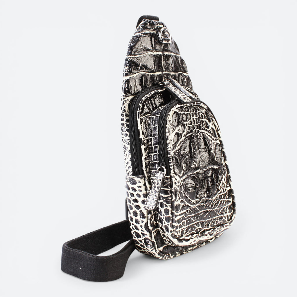 VEARI black and light brown bicolor hornback crocodile leather sling backpack with zip pockets.