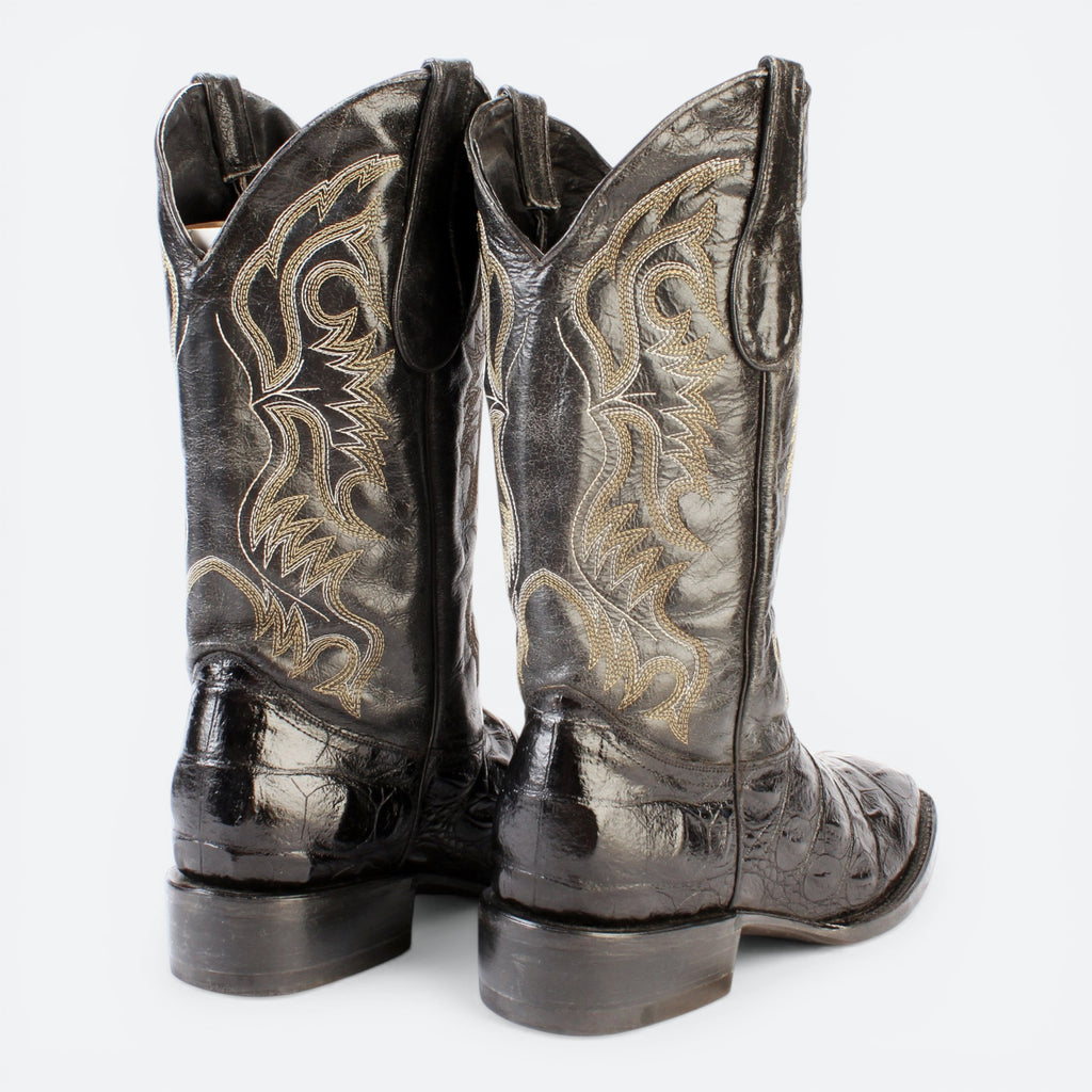 VEARI black hornback crocodile leather western boots with intricate gold stitching and leather sole.