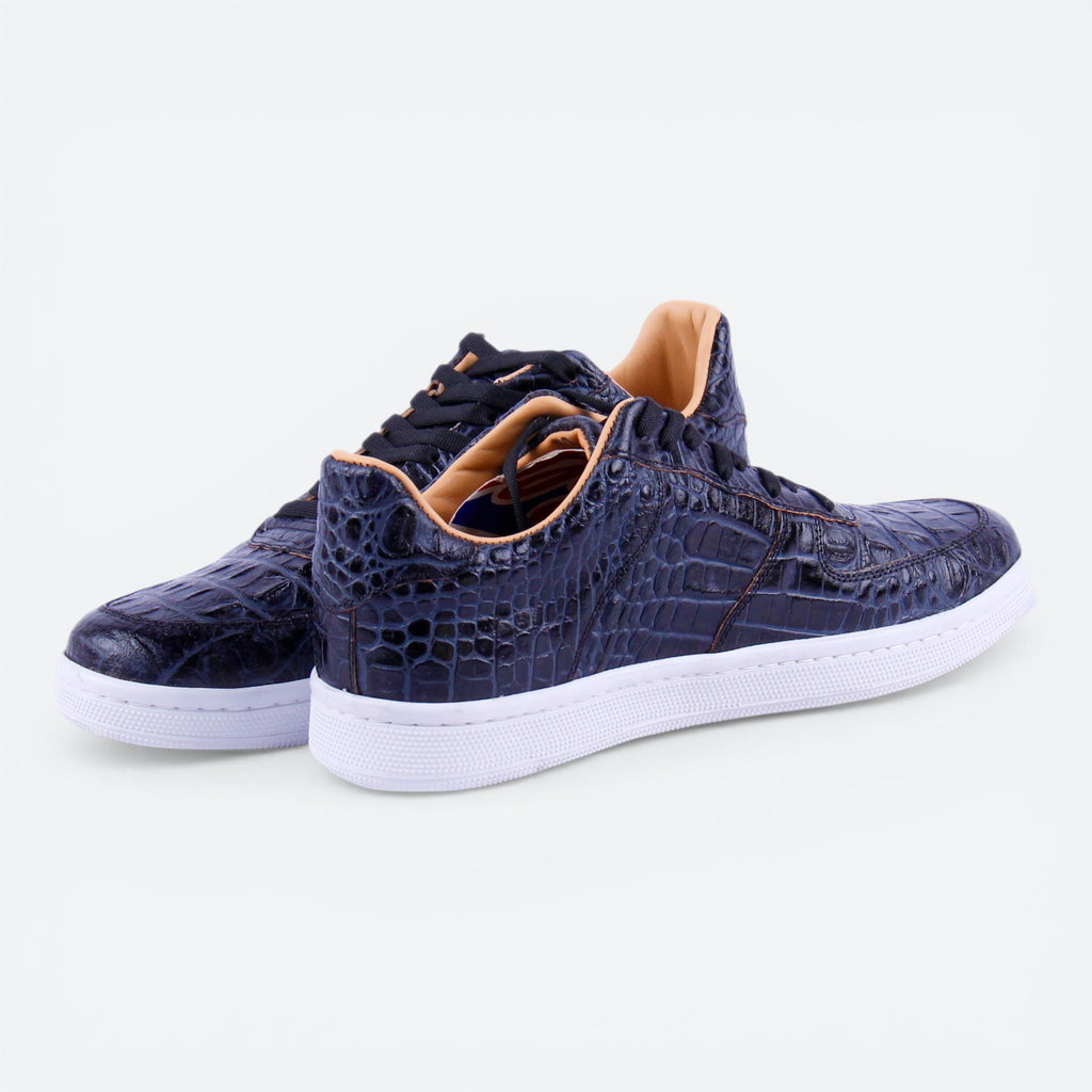 VEARI dark blue alligator leather low top sneakers with white soles and tan lining.